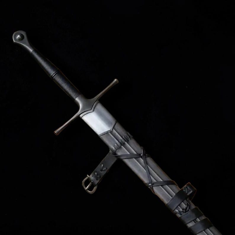 Medieval longsword partially sheathed in a dark leather scabbard against a black background