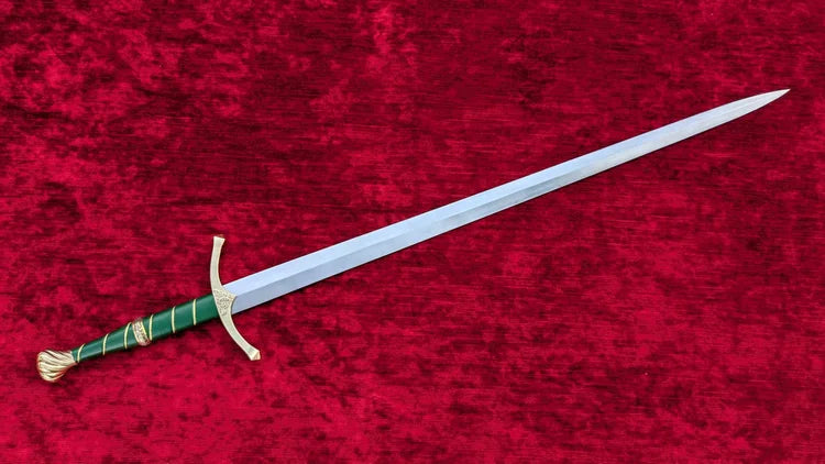 A medieval-style sword with a silver blade, green wrapped grip, and gold guard, displayed diagonally on a textured red velvet background.