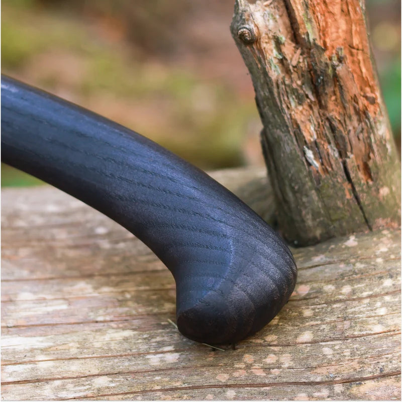 Black handle on a wooden surface with a blurred natural background