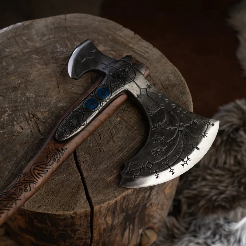 Decorative axe with wooden handle and metal head on a wooden surface