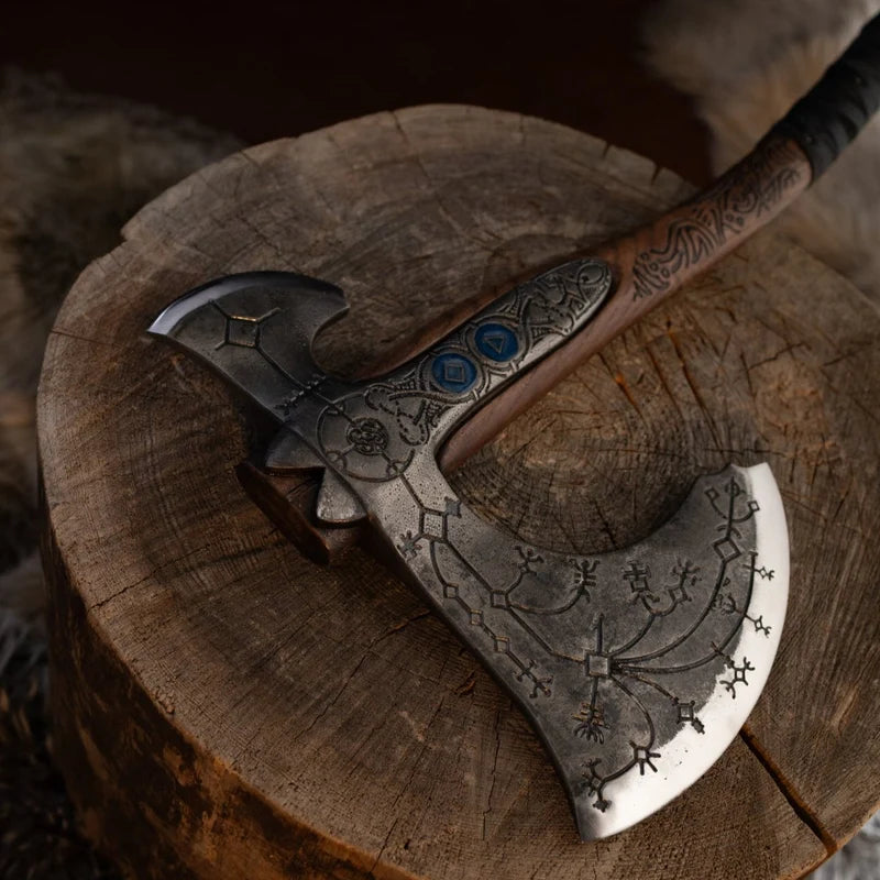 Decorative axe with intricate designs on a wooden stump
