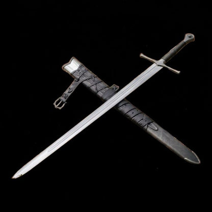 Medieval longsword and leather scabbard arranged diagonally against a black background