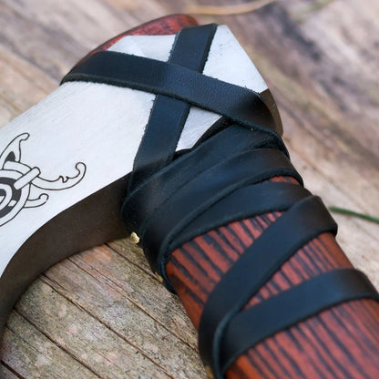 Wooden shoe with black straps on a wooden surface