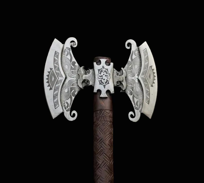 A double-headed battle axe with ornate silver metal blades featuring engraved tribal patterns and a dark brown textured handle, shown against a solid black background.