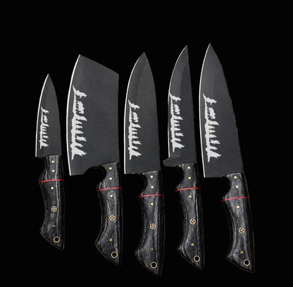 Four Japanese-style kitchen knives with dark gray blades featuring white kanji characters and black handles with gold and red accents, arranged on a newspaper background.