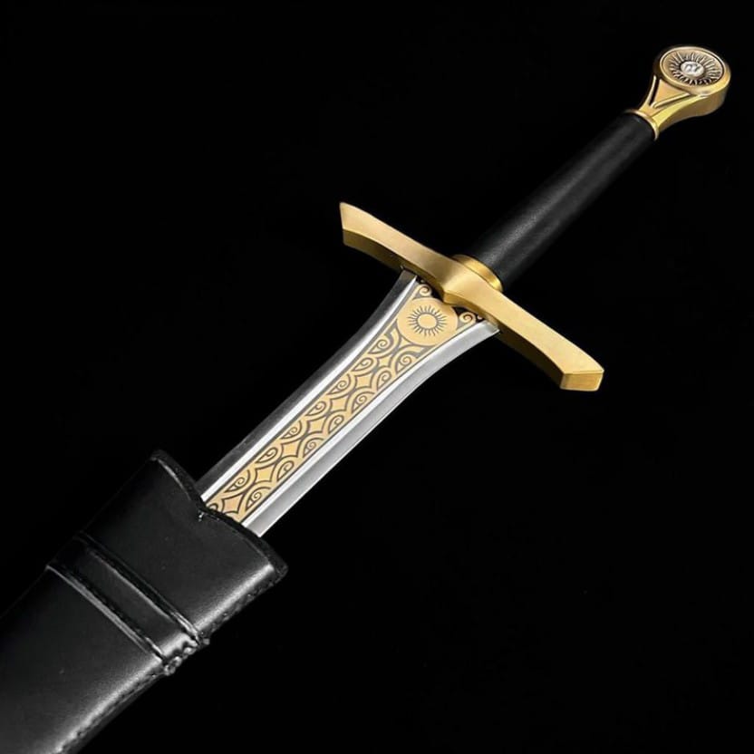 Close-up of the engraved brass guard, decorative details, and ergonomic handle of a handcrafted medieval fantasy collector sword.