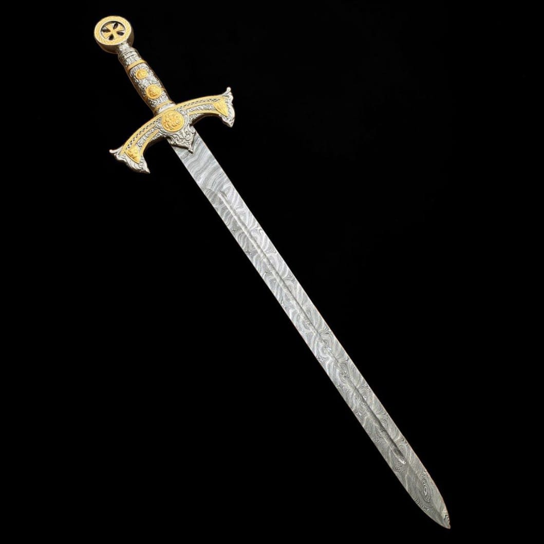 Angled view of a handmade Damascus steel Templar longsword with an engraved handle and polished patterned blade.