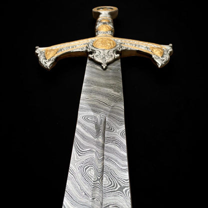 Close-up view of a handmade Damascus steel Templar sword blade showing detailed layered steel pattern and ornate crossguard.