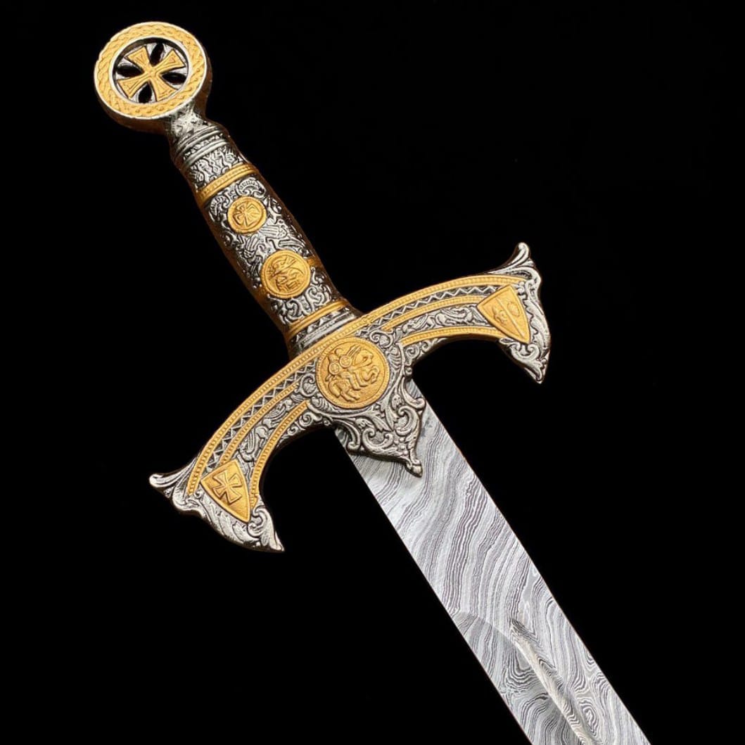 Detailed close-up of the handmade Templar sword handle, decorative crossguard, and Damascus steel blade pattern.